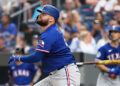 Texas Rangers designated hitter Rowdy Tellez swings a bat while wearing a blue jersey and blue batting helmet