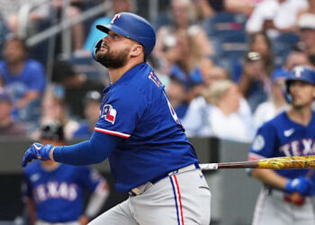 Texas Rangers designated hitter Rowdy Tellez swings a bat while wearing a blue jersey and blue batting helmet