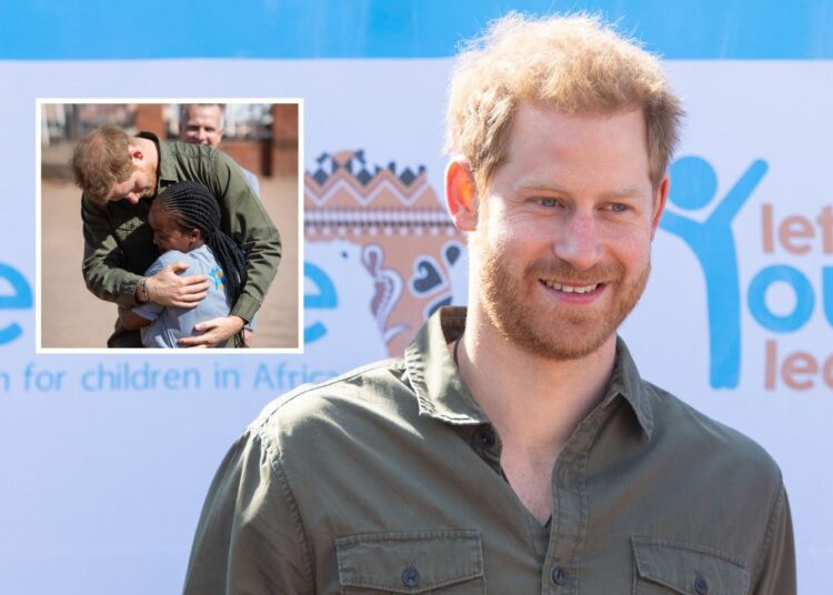 Prince Harry Hugs Child at Sentebale Center