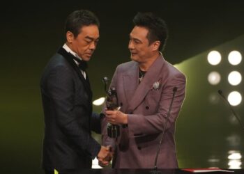 Francis Ng (right) presents Lau Ching-wan with the best actor statue at the 41st Hong Kong Film Awards ceremony in April 2023. Photo: SCMP