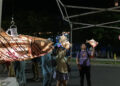 Passers-by look at illuminated sculptures by Kristian Brevik along Pine Street in Burlington on Sept. 6, 2024 during the South End Art Hop.