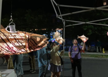 Passers-by look at illuminated sculptures by Kristian Brevik along Pine Street in Burlington on Sept. 6, 2024 during the South End Art Hop.