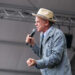John C. Reilly takes the stage to introduce performers during the final act on Sunday, July 27 at the Newport Folk Festival.