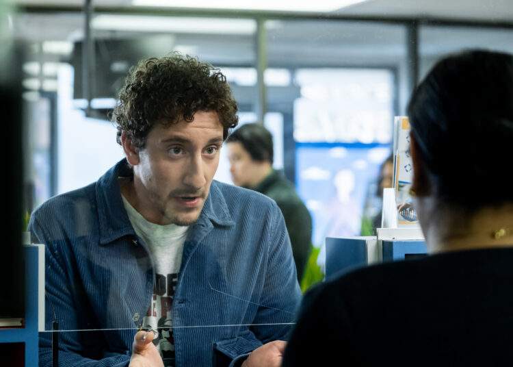 Malik Elassal as Samir, talking to a bank teller, in 'Adults.'