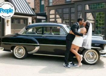 Jennifer Boris Leroy Garrett and Kam Williams kiss on their wedding day