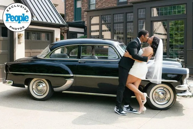 Jennifer Boris Leroy Garrett and Kam Williams kiss on their wedding day