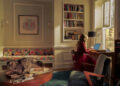 Cozy interior with a person working on a laptop and a cat