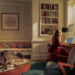 Cozy interior with a person working on a laptop and a cat