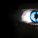 The Dead Zone promo image of a human iris with a silhouetted figure inside it.