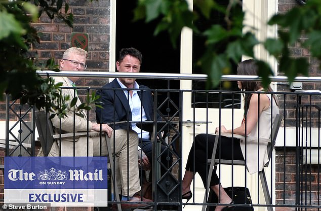 King Charles and Prince Harry's senior aides have held a secret peace summit in London (pictured: the head of communications for Royal Family Tobyn Andreae (left) and Meredith Maines head of communications for The Sussexes (right) with Liam Maguire, who runs the Sussexes' PR team in the UK (centre)