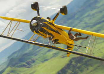 Tom Cruise hangs from a real-life airplane in