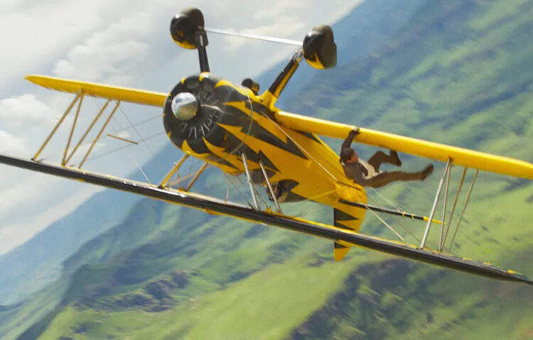 Tom Cruise hangs from a real-life airplane in