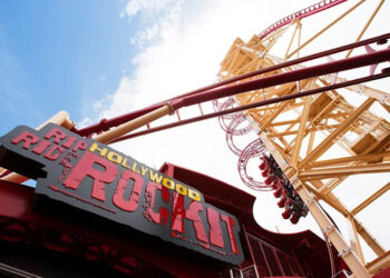 Press Photo of the sign and the giant launch of the red and yellow Hollywood Rip Ride Rockit coaster before its closing in August of 2025. .