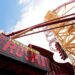 Press Photo of the sign and the giant launch of the red and yellow Hollywood Rip Ride Rockit coaster before its closing in August of 2025. .