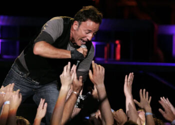 Bruce Springsteen sings to the crowd of fans, backed up by the E Street Band, during the final concert of their series at Giants Stadium in East Rutherford, New Jersey, on October 9, 2009.