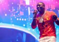 Image may contain Akon Performer Person Solo Performance Leisure Activities Music Musical Instrument and Musician