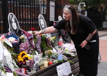 Floral tributes were left on the Black Sabbath Bridge bench on Broad Street in Birmingham following Ozzy Osbourne's death.