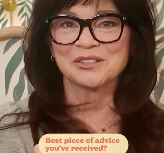 Valerie Bertinelli holding a card that says, "Best piece of advice you've received? NOT TO DO."