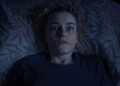 Julia Garner looks terrified in her bed in Weapons.