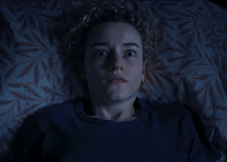 Julia Garner as Justine in bed in Weapons.