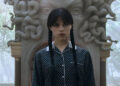 Wednesday in front of Medusa-shaped fireplace outdoors in Wednesday Season 2.