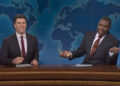 Colin Jost and Michael Che behind Weekend Update desk in SNL Season 50.