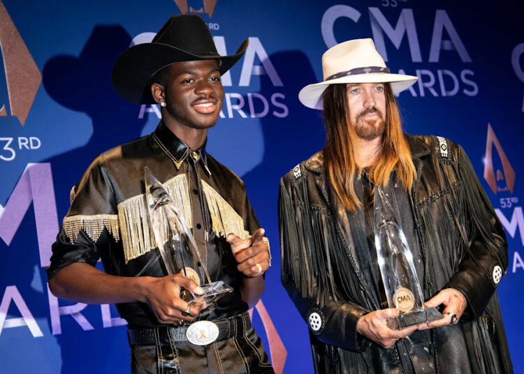 Lil Nas X, left, and Billy Ray Cyrus show off their Musical Event of the Year award backstage during the 53rd annual CMA Awards show at Bridgestone Arena in Nashville on Nov. 13, 2019.