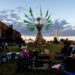Dozens of festival goers wait for “Our Lady of Artica” to be set ablaze Sunday, Oct. 8, 2023, during the Artica Urban Art Festival along the Mississippi Riverfront in downtown St. Louis.