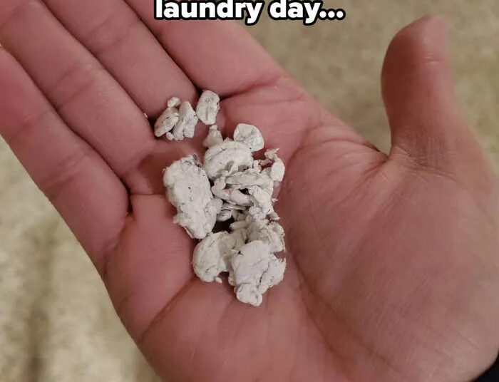 Bits of chewed gum rest in an open palm