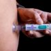 Person injecting Mounjaro pen.