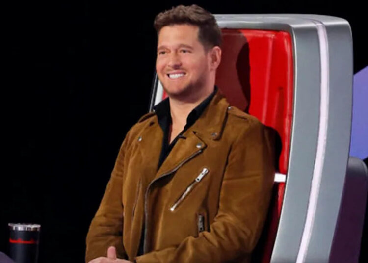 Michael Buble smiles as he listens to a Blind Audition on The Voice Season 28.