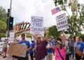 Demonstrators picket in response to the suspension of Jimmy Kimmel's late-night show outside of The Walt Disney Studios Thursday, Sept. 18, 2025, in Burbank, Calif.]