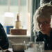 Spike sitting at table with Jimmy Cult members in 28 Years Later: The Bone Temple.