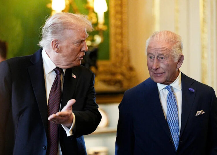 US President Donald Trump (left) and King Charles III view items on display during a visit to the Royal Collection exhibition in the Green Drawing Room at Windsor Castle (PA)