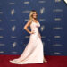 Kit Hoover wears a white satin gown.