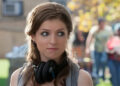 Anna Kendrick with headphones around neck in Pitch Perfect .