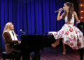 Ariana Grande sings on a piano that Jimmy Fallon in a blonde wig plays.