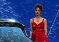 Still from Megadoc of a person in a red dress.