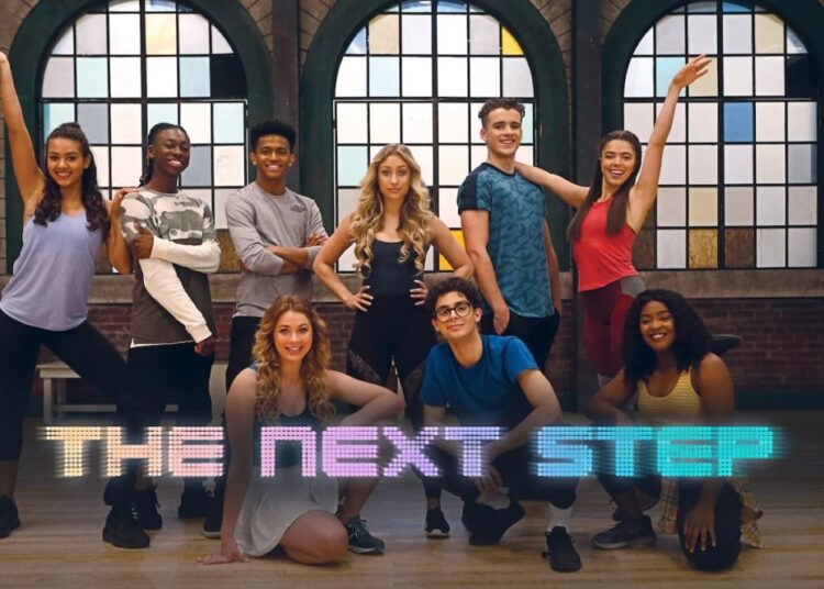 nine young people stand in a group in various dance poses. the words "The Next Step" run across the bottom of the image