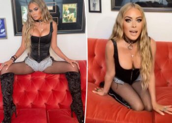 Carmen Electra rocks corset top and fishnet stockings in racy photo shoot