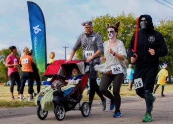 People in Halloween costumes running