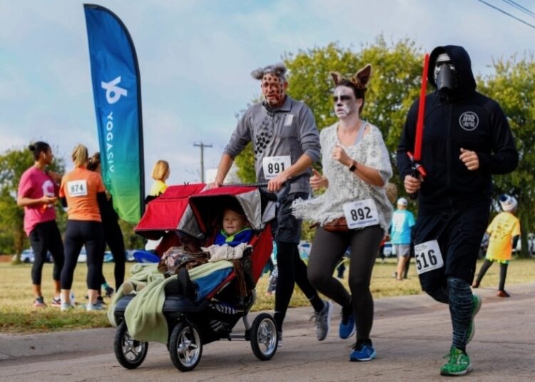 People in Halloween costumes running