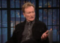Conan O'Brien speaking with Seth Meyers on Late Night.