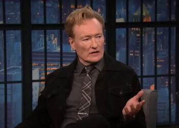 Conan O'Brien speaking with Seth Meyers on Late Night.