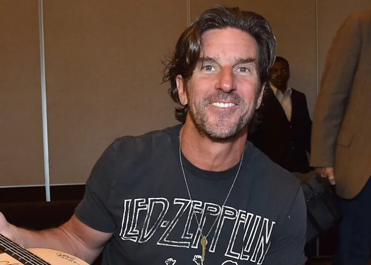 Brett James holding a guitar