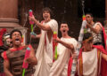 Fraternity brothers with water toys having fun in Amazon Prime's Overcompensating Season 1.