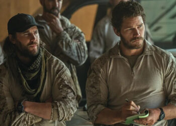 From left to right: Taylor Kitsch standing with his arms crossed and Chris Pratt writing on a notepad in The Terminal List: Dark Wolf. .