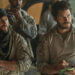 From left to right: Taylor Kitsch standing with his arms crossed and Chris Pratt writing on a notepad in The Terminal List: Dark Wolf. .