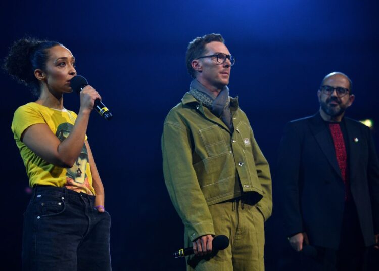 Ruth Negga, Benedict Cumberbatch and Amer Hlehel speak onstage during the Together For Palestine concert.