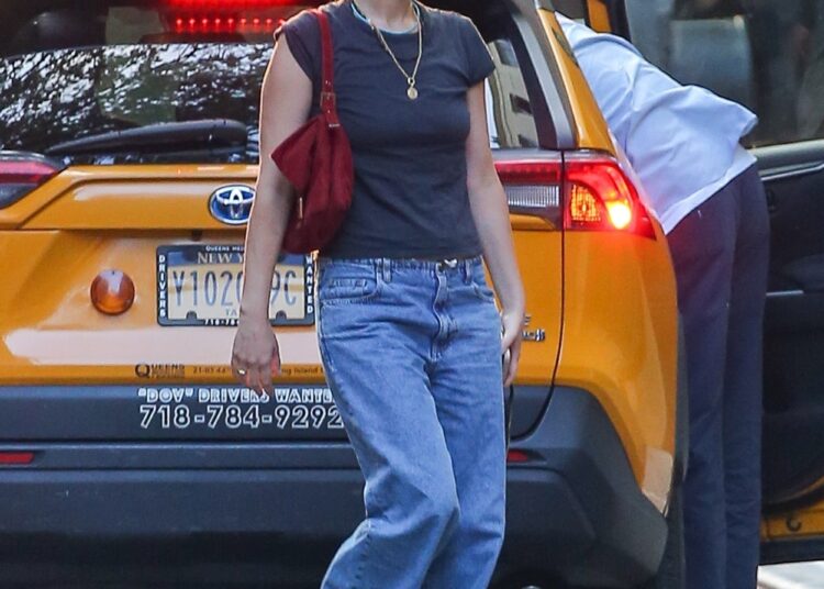 Jennifer Lawrence gets out of her car in drawstring jeans and a T-shirt